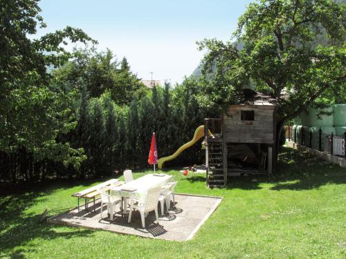 a backyard with a table and chairs and a playground at Holiday Home Aster by Interhome in Tösens