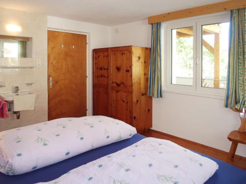 a bedroom with a bed and a sink and a window at Holiday Home Aster by Interhome in Tösens