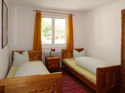 a bedroom with two beds and a window at Holiday Home Aster by Interhome in Tösens