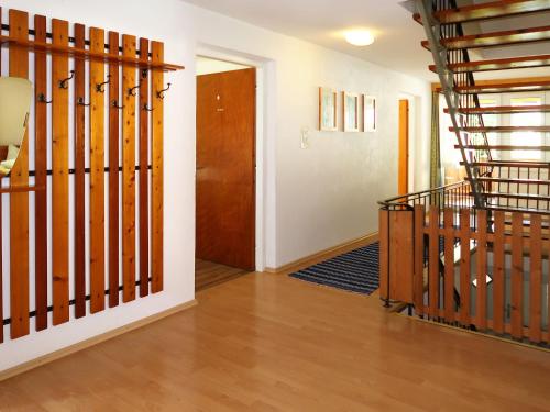 a hallway with a wooden staircase and a door at Holiday Home Aster by Interhome in Tösens