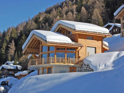 a log cabin in the snow with snow covered at Chalet Chalet Aquarius by Interhome in Nendaz