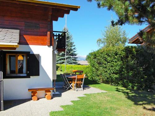a patio of a house with a table and a bench at Chalet Coucordin by Interhome in Nendaz