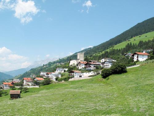 a small village on a hill in a green field at Apartment Burg Biedenegg- Sigwein by Interhome in Fliess