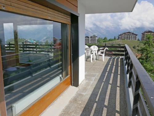 a balcony with a view of the mountains at Apartment Christiania I F4 by Interhome in Nendaz