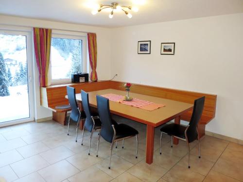 a dining room with a wooden table and chairs at Apartment Apart Sonja by Interhome in Kappl