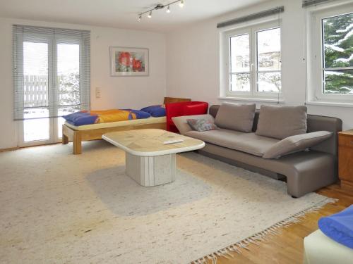 a living room with a couch and a table at Apartment Dobler - LNR110 by Interhome in Lorüns