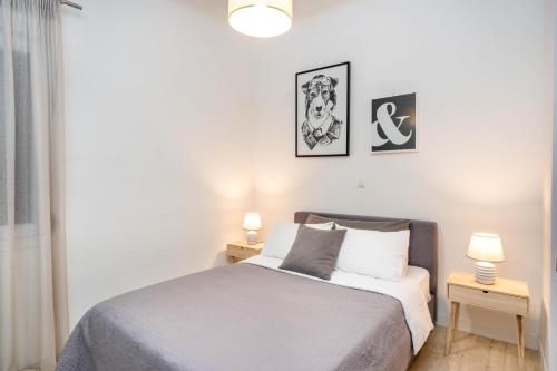 a bedroom with a bed with two night stands and two lamps at Morum Athens Urban Stay in Athens