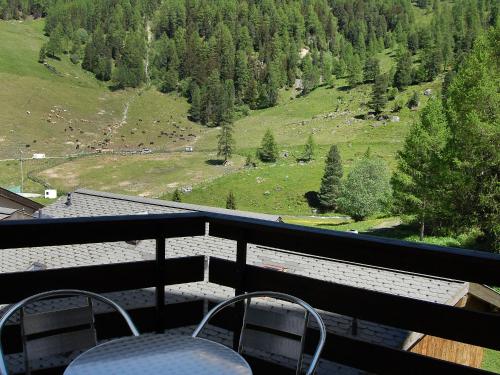 a balcony with chairs and a view of a mountain at Apartment Mont Fort 16 by Interhome in Siviez