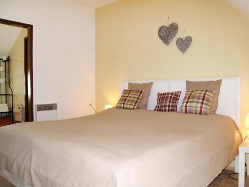 a bedroom with a white bed with hearts on the wall at Holiday Home Hofgasse-2 by Interhome in Mörbisch am See