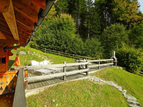 a wooden bench next to a wooden fence at Chalet Saint Piran-1 by Interhome in Villars-sur-Ollon