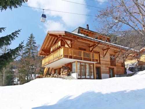 a log home in the snow with a ski lift at Chalet Khamariah by Interhome in Villars-sur-Ollon