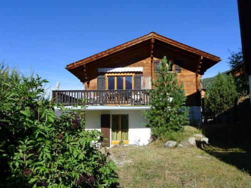a house with a balcony on top of it at Chalet Rietsli by Interhome in Grächen