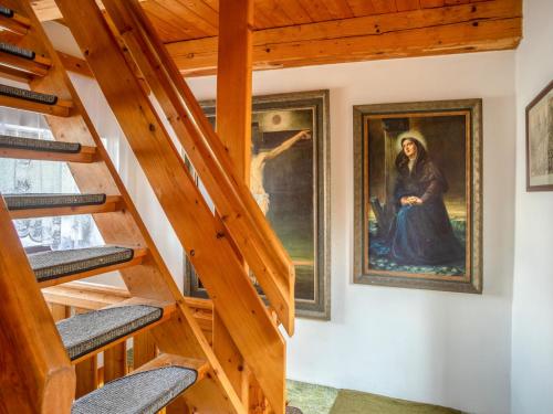 a staircase in a house with a painting on the wall at Chalet Panorama by Interhome in Dehtáře