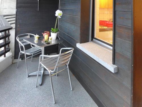a table and chairs sitting on a patio at Apartment Cransalpin Apt- 3 - Secteur 1 by Interhome in Vermala