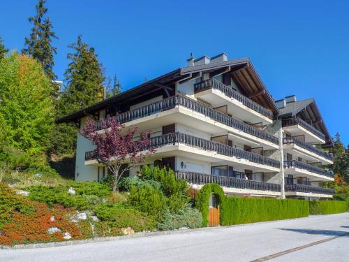 a building with balconies on the side of a road at Apartment Mandarin-3 by Interhome in Vermala