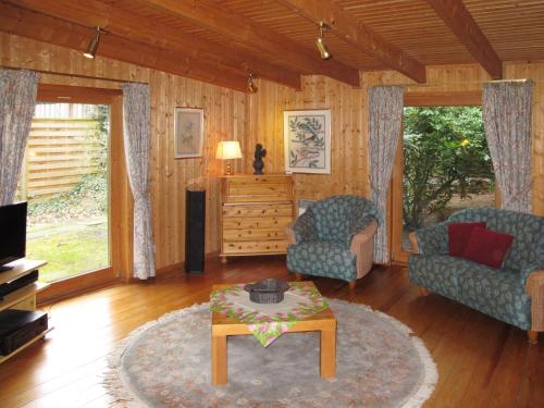 a living room with a couch and a coffee table at Chalet Fietz by Interhome in Nienkattbek