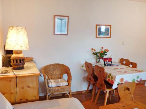 a dining room with a table and chairs and a lamp at Apartment Châtillon C 16 by Interhome in Ovronnaz