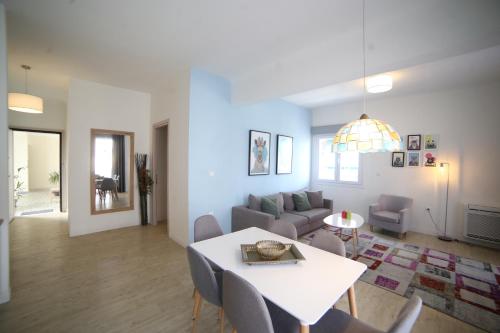 a living room with a table and a couch at Morum Athens Urban Stay in Athens