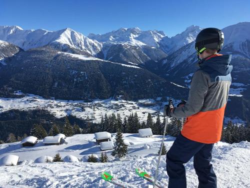 a man standing on top of a snow covered mountain at Apartment Aragon M86 by Interhome in Fiesch