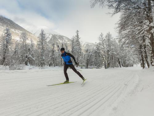 a man is skiing down a snow covered slope at Apartment Aragon M86 by Interhome in Fiesch