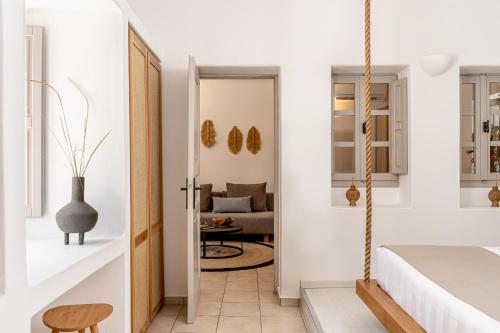 a bedroom with a bed and a living room at Marillia Village in Perivolos