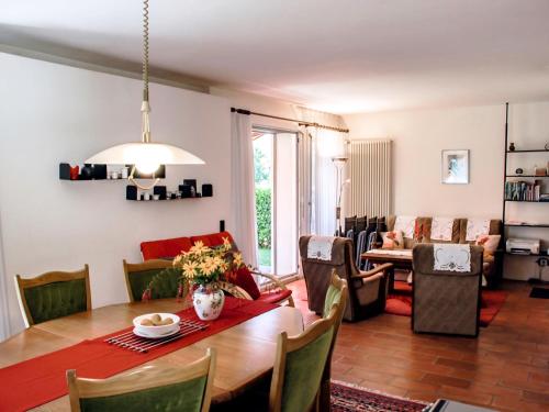 a dining room and living room with a table and chairs at Holiday Home Ar Ronchée N- 9 by Interhome in Astano
