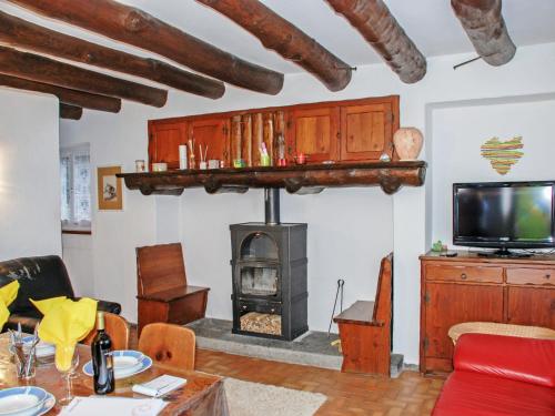 a living room with a wood stove and a tv at Holiday Home Casa la Rustica by Interhome in Brione