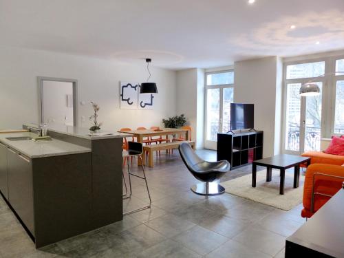 a living room with a kitchen and a dining room at Apartment Modern by Interhome in Interlaken