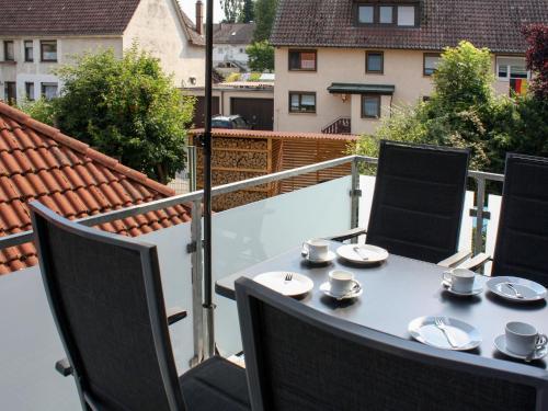a table with cups and saucers on a balcony at Apartment Land in Sicht by Interhome in Rulfingen