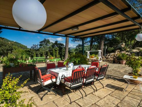 a patio with a table and chairs under awning at Holiday Home S'Hort des Verger by Interhome in Esporles