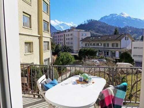 einen weißen Tisch und Stühle auf einem Balkon mit Bergblick in der Unterkunft Studio Galeriestudio Jungfraublick by Interhome in Interlaken