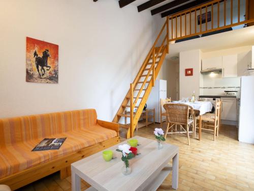 a living room with a couch and a table at Holiday Home Les Maisons de la Plage-8 by Interhome in Le Grau-du-Roi