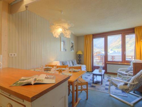een woonkamer met een tafel en een bank bij Apartment Le Curling B - Val Claret-27 by Interhome in Tignes