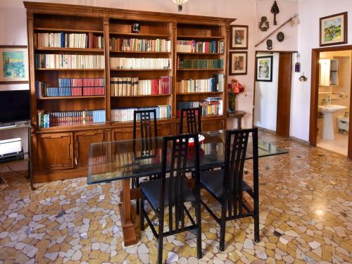 a dining room with a glass table and some bookshelves at Apartment Campo Santa Maria Formosa by Interhome in Venice