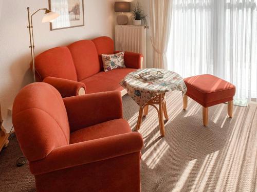 a living room with a couch and a table at Apartment Dehne-2 by Interhome in Norddeich
