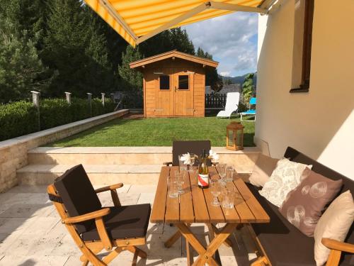 a wooden table and chairs on a patio at Holiday Home Seekarblick by Interhome in Achenkirch