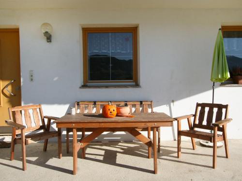 a wooden table with two chairs and a pumpkin on it at Apartment Eberharter-1 by Interhome in Hart im Zillertal