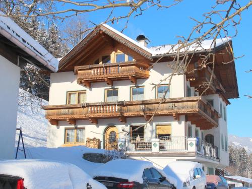 a house with a balcony in the snow at Apartment Herbert-1 by Interhome in Emberg