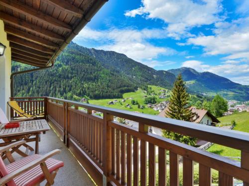 a balcony with a bench and a view of mountains at Apartment Illyria by Interhome in Ortisei