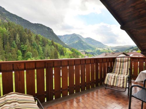 a balcony with chairs and a view of mountains at Apartment Demetz by Interhome in Ortisei