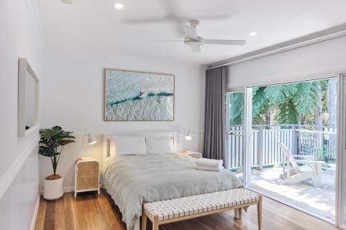 a bedroom with a bed and a large window at Sunrise Guesthouse in Byron Bay