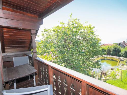 a balcony with a bench and a view of a pool at Apartment Schnitzer by Interhome in Seeboden