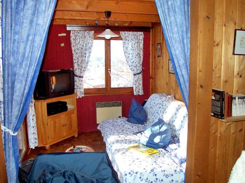 a living room with a couch and a window at Chalet Gerbepal by Interhome in Gerbépal