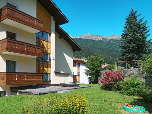 a building with a grass yard next to a building at Apartment Haupthaus Schönblick - SVH116 by Interhome in San Valentino alla Muta