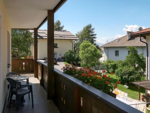 a balcony with a table and chairs and flowers at Apartment Haupthaus Schönblick - SVH119 by Interhome in San Valentino alla Muta