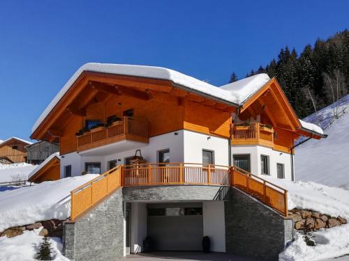 a house with a balcony in the snow at Apartment Spieglhof-2 by Interhome in Sarntal