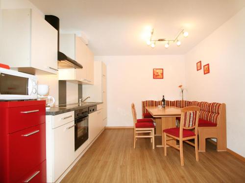 a kitchen and dining room with a table and chairs at Apartment Venet by Interhome in Fliess