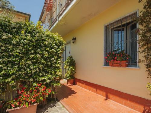 a house with potted plants and a window at Holiday Home Giuliana by Interhome in Massa