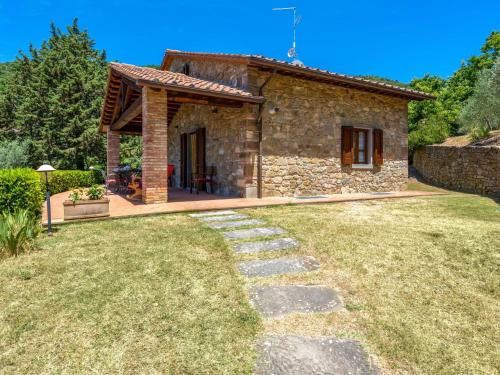 a small stone house with a pathway leading to it at Holiday Home Il Sorbino by Interhome in Fondaccio