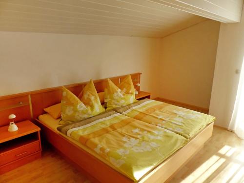a bedroom with a large bed with yellow pillows at Apartment Schallhart by Interhome in Terfens